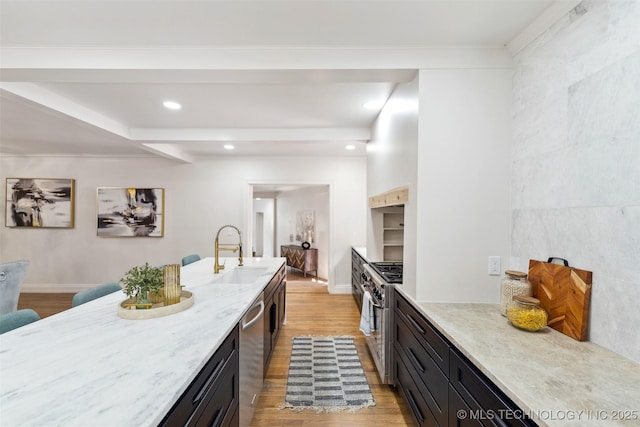 302 E 29th St, Tulsa, OK 74114 - kitchen with stainless steel appliances, light wood-style floors, light stone countertops, dark cabinetry, and recessed lighting