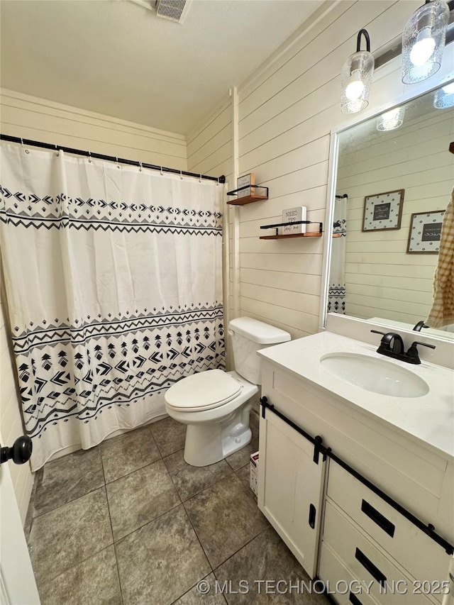 509 W Ryan St, Catoosa, OK 74015 - bathroom featuring vanity, toilet, tile patterned floors, wood walls, and a shower with curtain
