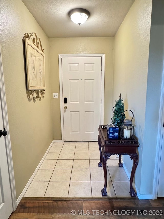 509 W Ryan St, Catoosa, OK 74015 - entryway featuring a textured ceiling, light tile patterned floors, and baseboards