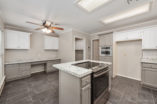 4908 S Redbud Ave, Broken Arrow, OK 74011 - kitchen with gray cabinetry, stainless steel appliances, a ceiling fan, a kitchen island, and crown molding