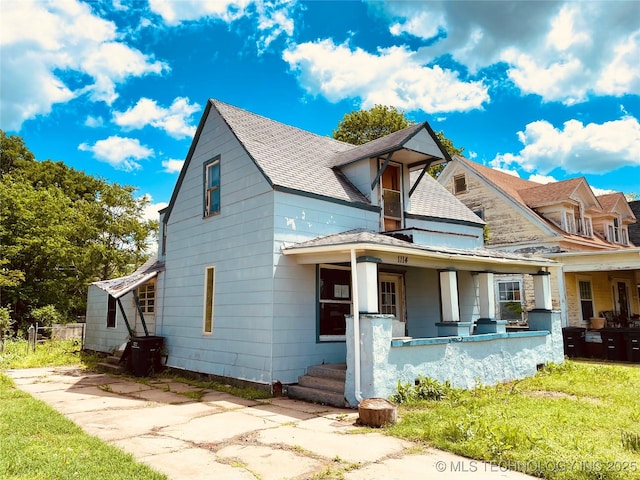 1114 S Keeler Ave, Bartlesville, OK 74003 - view of front of home with a shingled roof, a porch, and a front lawn