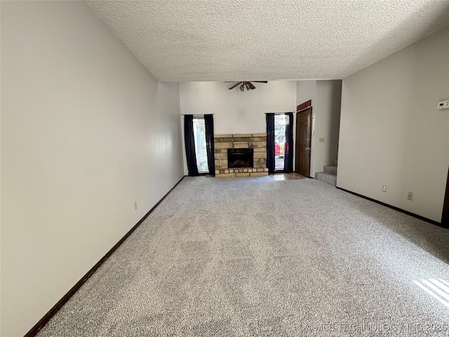 5269 Nowata Unit O-101, Bartlesville, OK 74006 - unfurnished living room with light carpet, a textured ceiling, a fireplace, and baseboards