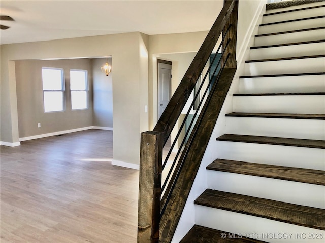 1423 E Walnut St, Cushing, OK 74023 - staircase with baseboards and wood finished floors