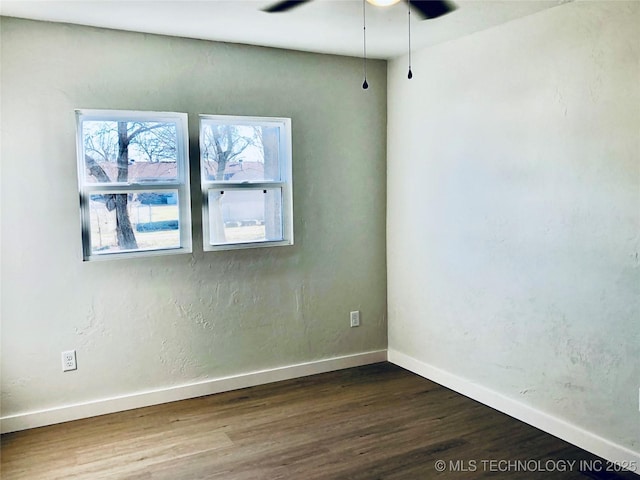 1423 E Walnut St, Cushing, OK 74023 - unfurnished room with dark wood-style flooring, baseboards, and ceiling fan