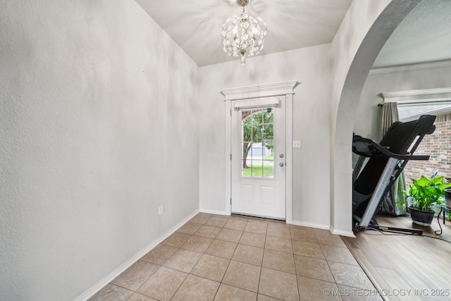 109 W 133rd Pl, Skiatook, OK 74070 - tiled entryway featuring arched walkways, a chandelier, and baseboards