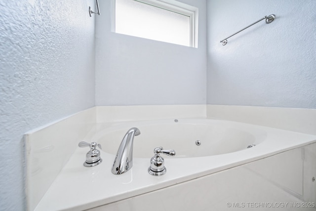 109 W 133rd Pl, Skiatook, OK 74070 - bathroom featuring a textured wall and a whirlpool tub