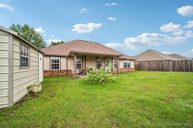109 W 133rd Pl, Skiatook, OK 74070 - back of house with a shingled roof, brick siding, and a patio area