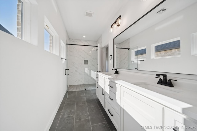 2410 W Charleston St, Broken Arrow, OK 74011 - bathroom with a marble finish shower, double vanity, tile patterned flooring, and recessed lighting