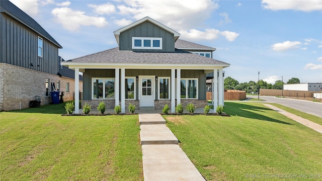 2410 W Charleston St, Broken Arrow, OK 74011 - view of front of house with board and batten siding, covered porch, a shingled roof, and brick siding