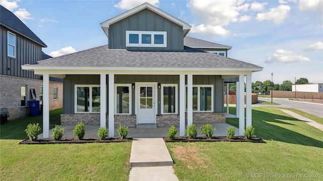 2410 W Charleston St, Broken Arrow, OK 74011 - view of front of house featuring covered porch, board and batten siding, a shingled roof, and brick siding