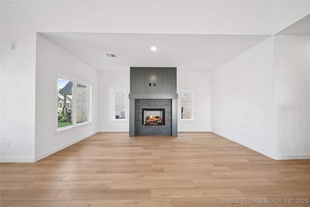 2410 W Charleston St, Broken Arrow, OK 74011 - unfurnished living room with light wood finished floors, baseboards, recessed lighting, and a tile fireplace
