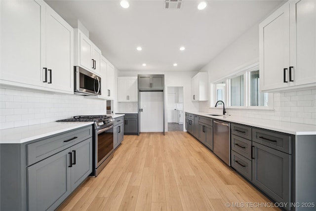 2410 W Charleston St, Broken Arrow, OK 74011 - kitchen with stainless steel appliances, gray cabinets, recessed lighting, and a sink