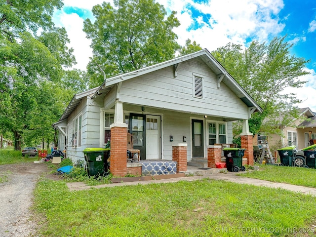 309 W 14th, Ada, OK 74820 - view of front facade featuring a porch and a front yard