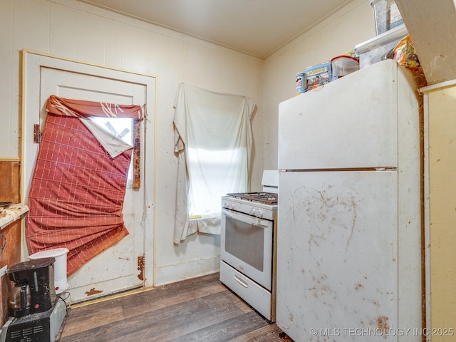 309 W 14th, Ada, OK 74820 - kitchen with white appliances, ornamental molding, and wood finished floors