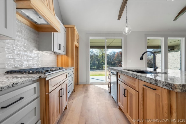 2332 E 135th Dr S, Bixby, OK 74008 - kitchen with a sink, stainless steel appliances, light wood-style flooring, backsplash, and light stone countertops
