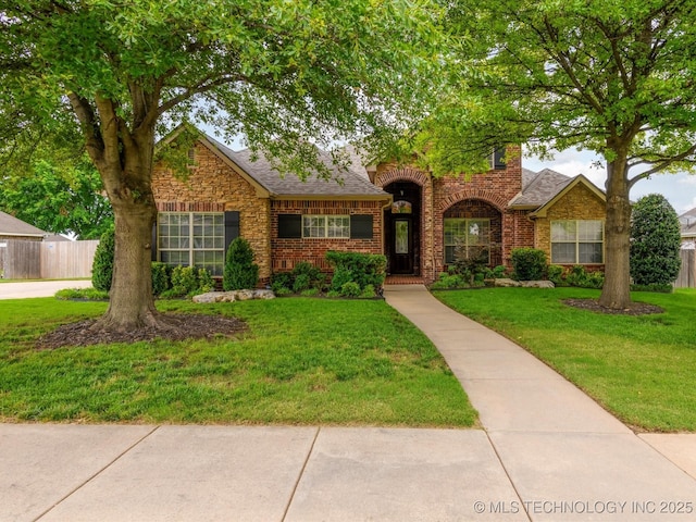 5816 Woodland Rd, Bartlesville, OK 74006 - traditional-style house featuring brick siding and roof with shingles