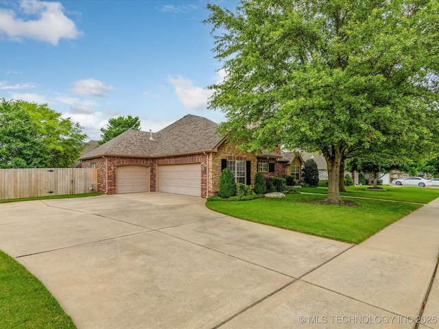 5816 Woodland Rd, Bartlesville, OK 74006 - view of front facade with an attached garage, brick siding, driveway, and a shingled roof