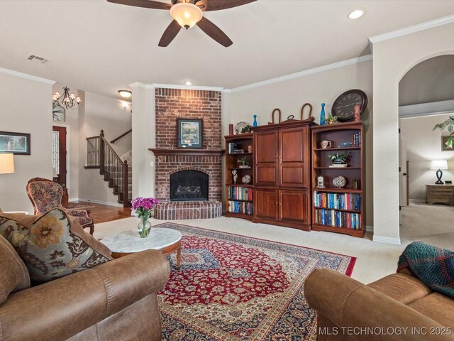 5816 Woodland Rd, Bartlesville, OK 74006 - carpeted living area featuring stairway, a ceiling fan, a brick fireplace, crown molding, and recessed lighting