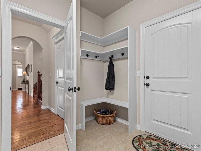 5816 Woodland Rd, Bartlesville, OK 74006 - mudroom with arched walkways and light tile patterned floors