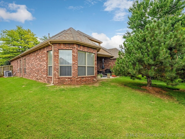 5816 Woodland Rd, Bartlesville, OK 74006 - rear view of property with brick siding and a yard