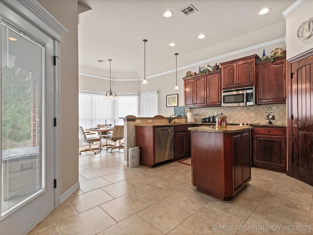 5816 Woodland Rd, Bartlesville, OK 74006 - kitchen with stainless steel appliances, backsplash, light tile patterned floors, a peninsula, and a center island