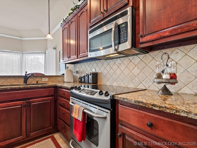 5816 Woodland Rd, Bartlesville, OK 74006 - kitchen featuring appliances with stainless steel finishes, reddish brown cabinets, decorative backsplash, and crown molding