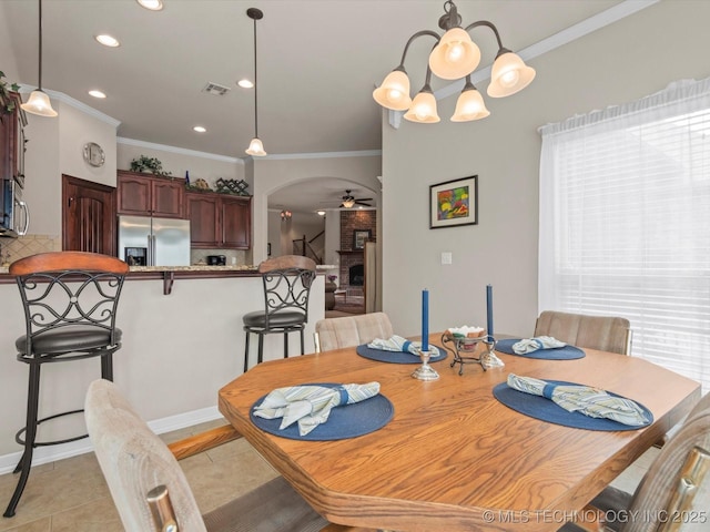 5816 Woodland Rd, Bartlesville, OK 74006 - dining room with arched walkways, a ceiling fan, ornamental molding, recessed lighting, and a chandelier
