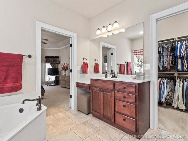 5816 Woodland Rd, Bartlesville, OK 74006 - bathroom with vanity, a bath, a walk in closet, and tile patterned flooring