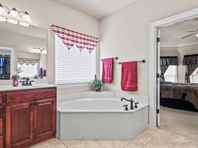 5816 Woodland Rd, Bartlesville, OK 74006 - ensuite bathroom featuring a bath, vanity, healthy amount of natural light, and a ceiling fan
