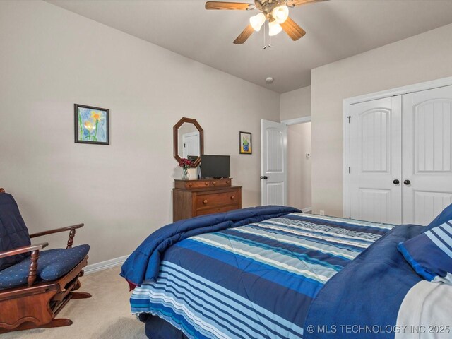5816 Woodland Rd, Bartlesville, OK 74006 - bedroom with carpet, a closet, and a ceiling fan