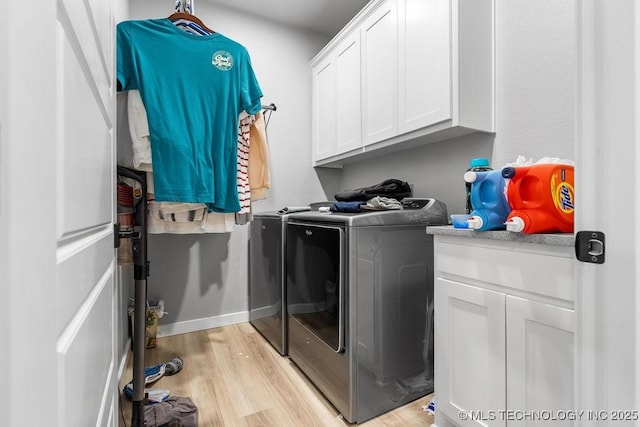 40 Wilson Pkwy, Durant, OK 74701 - laundry area with washing machine and clothes dryer, light wood-style flooring, and cabinet space