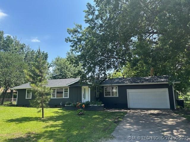 111 E 13th Pl, Claremore, OK 74017 - ranch-style home with an attached garage, asphalt driveway, and a front lawn