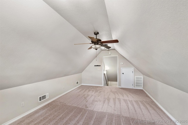 18932 Spring Creek Ln, Claremore, OK 74017 - bonus room with a ceiling fan, vaulted ceiling, carpet flooring, baseboards, and a textured ceiling