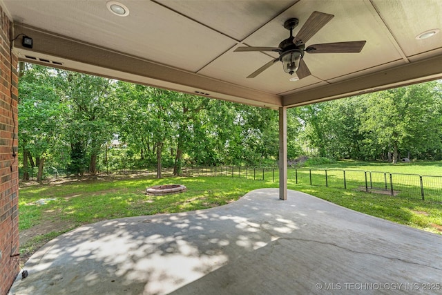 18932 Spring Creek Ln, Claremore, OK 74017 - view of patio featuring a ceiling fan, view of scattered trees, and an outdoor fire pit