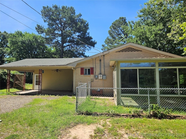 2700 N Witte St, Poteau, OK 74953 - view of front facade featuring brick siding, a carport, gravel driveway, a gate, and ceiling fan