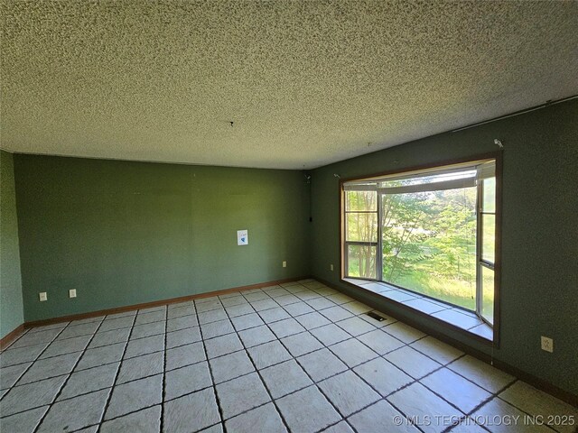 2700 N Witte St, Poteau, OK 74953 - tiled spare room with a textured ceiling