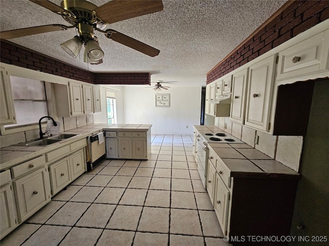 2700 N Witte St, Poteau, OK 74953 - kitchen with a sink, white appliances, a ceiling fan, a peninsula, and a textured ceiling
