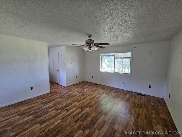 2700 N Witte St, Poteau, OK 74953 - empty room featuring dark wood finished floors, ceiling fan, a textured ceiling, and baseboards
