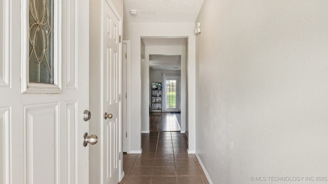 4964 SE Brookline Dr, Bartlesville, OK 74006 - corridor featuring baseboards and dark tile patterned flooring