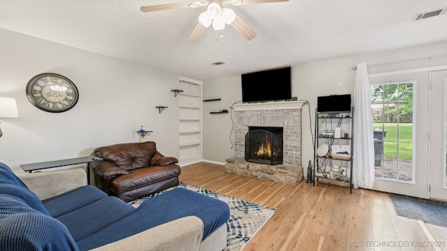 4964 SE Brookline Dr, Bartlesville, OK 74006 - living area featuring wood finished floors, a fireplace, and ceiling fan