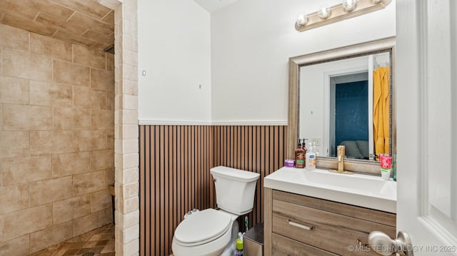 4964 SE Brookline Dr, Bartlesville, OK 74006 - bathroom featuring vanity, a stall shower, and a wainscoted wall