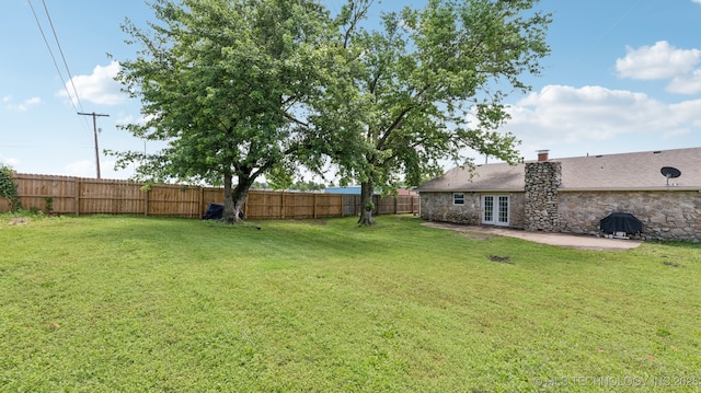 4964 SE Brookline Dr, Bartlesville, OK 74006 - fenced backyard with french doors and a patio