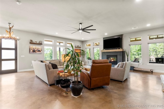 8562 Adams Creek Rd, Beggs, OK 74421 - living area featuring a fireplace, concrete flooring, healthy amount of natural light, and recessed lighting
