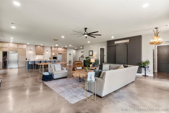 8562 Adams Creek Rd, Beggs, OK 74421 - living room featuring finished concrete floors, recessed lighting, ceiling fan, a chandelier, and baseboards