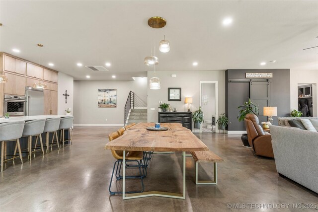 8562 Adams Creek Rd, Beggs, OK 74421 - dining space with concrete flooring, baseboards, recessed lighting, and stairway