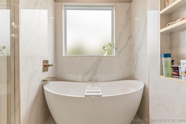 8562 Adams Creek Rd, Beggs, OK 74421 - full bathroom featuring tile walls and a soaking tub