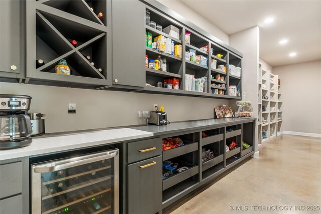 8562 Adams Creek Rd, Beggs, OK 74421 - indoor dry bar with wine cooler, concrete flooring, baseboards, and recessed lighting