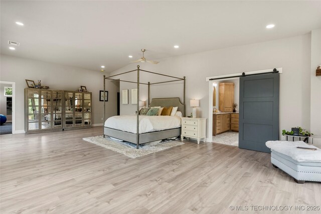 8562 Adams Creek Rd, Beggs, OK 74421 - bedroom with a barn door, light wood-style floors, recessed lighting, baseboards, and ensuite bath