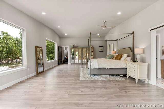 8562 Adams Creek Rd, Beggs, OK 74421 - bedroom with recessed lighting, light wood-style flooring, lofted ceiling, baseboards, and a barn door