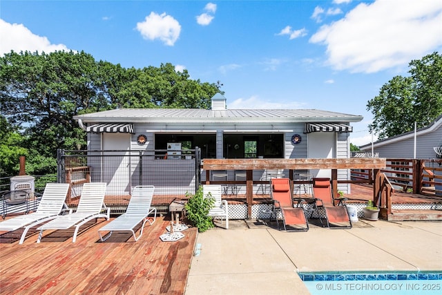 168 Murray Ln, Strang, OK 74367 - rear view of house featuring a deck, metal roof, a patio, and a chimney